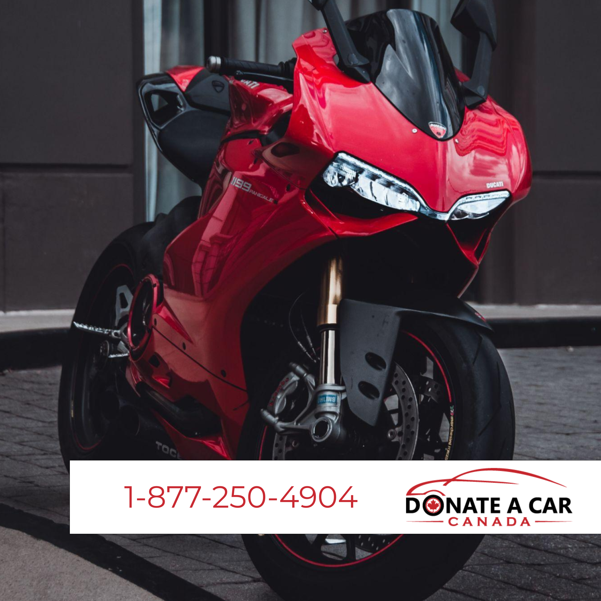 Cherry red motorcycle parked near a brick building. Donate a Car Canada logo and phone number for Harley Davidson donation